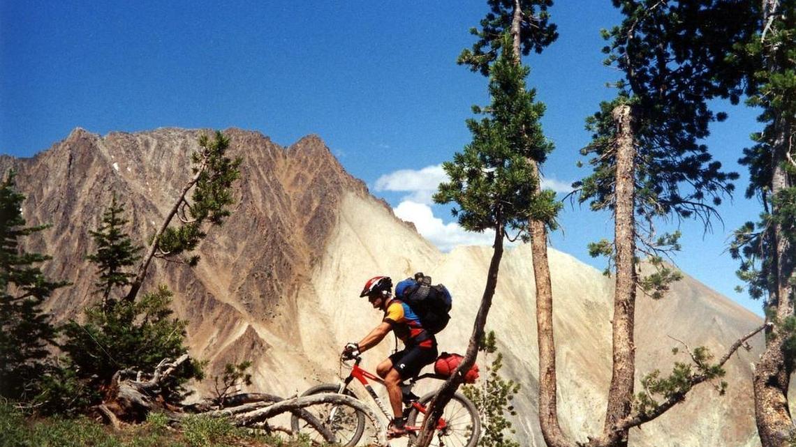 A mountain biker pedals over the pass overlooking Castle Peak prior to its inclusion in the White Clouds Wilderness in legislation in 2015.