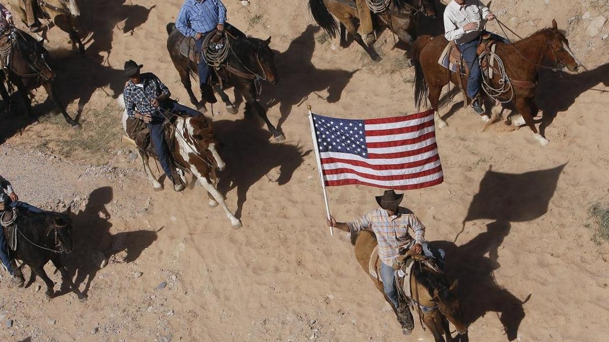 In this April 12, 2014, file photo, the Bundy family and their supporters fly the American flag.