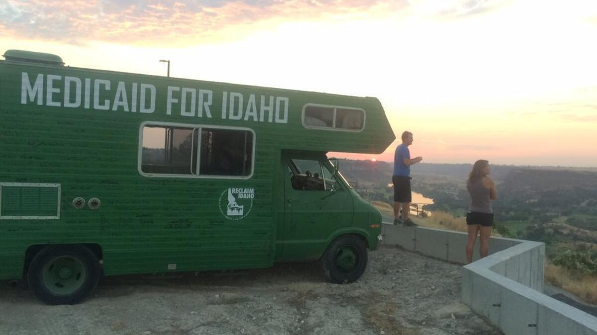 Garrett Strizich, left co-founder of Reclaim Idaho, and Emily Strizich, a Reclaim Idaho activist, at the Snake River Canyon in Twin Falls. Reclaim Idaho invited people to sign the green camper as it traveled the state, making it a giant rolling petition for expanding access to health care in Idaho.
