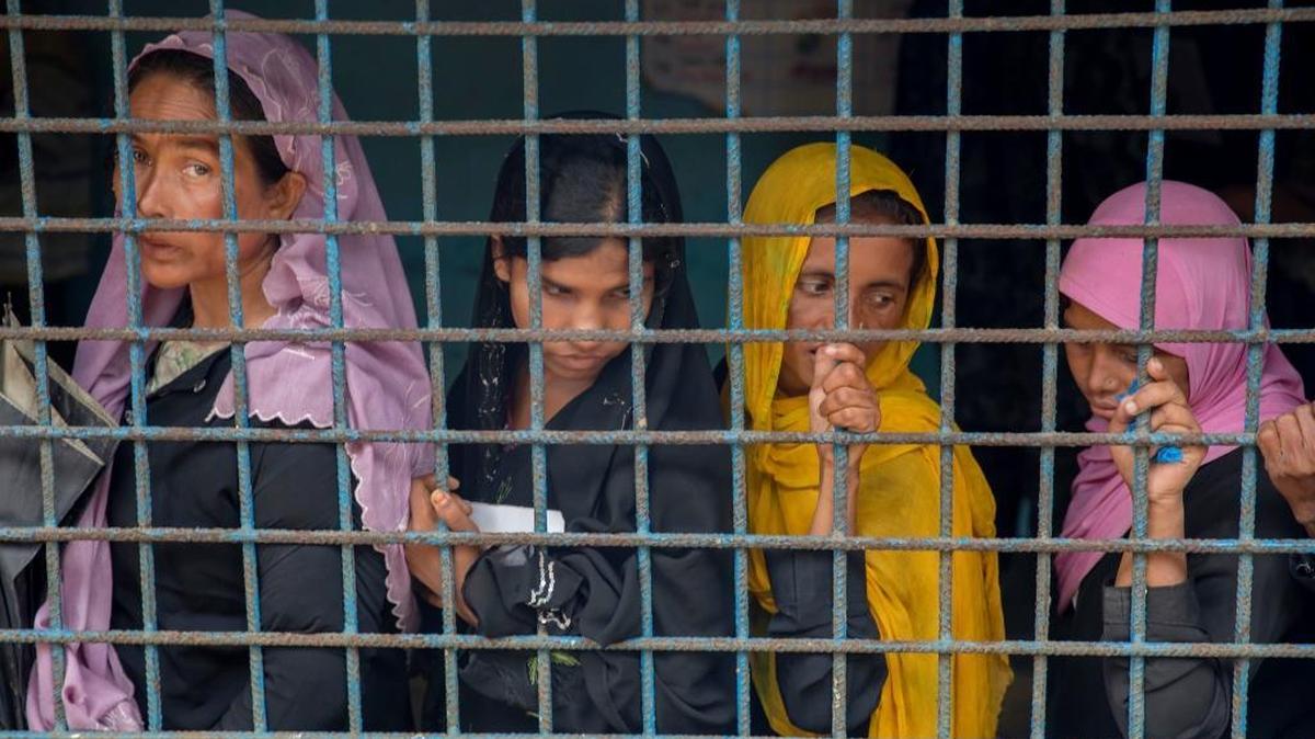 Rohingya Muslim women, who crossed over from Myanmar into Bangladesh, wait to register at the Kutupalong refugee camp Oct. 20.