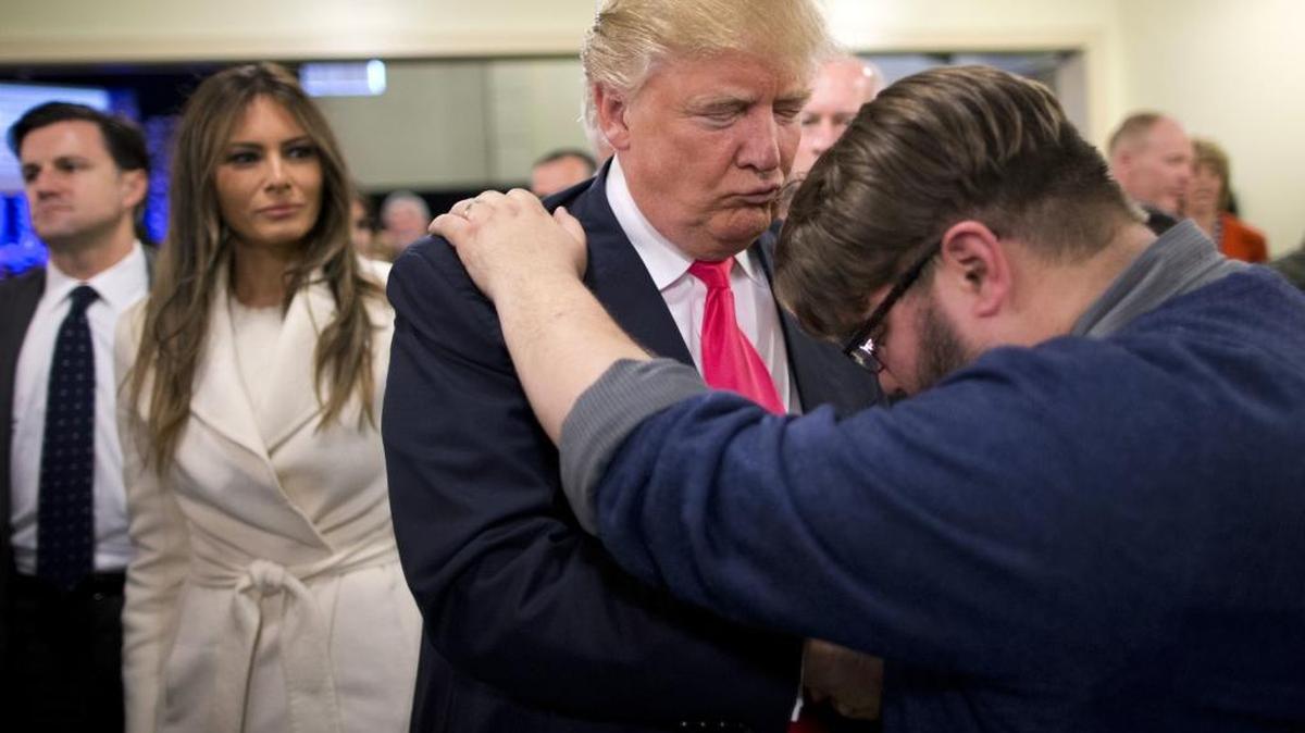 Pastor Joshua Nink, right, prays for Republican presidential candidate Donald Trump at First Christian Church, in Council Bluffs, Iowa, in January 2016.