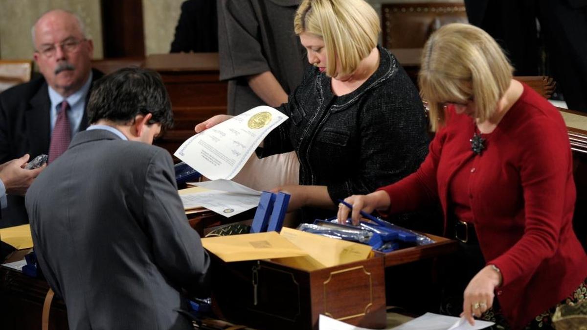 FILE - In this Jan. 4, 2013 file photo, clerks review the state Electoral College certificates during a Joint Session of Congress in the House Chamber on Capitol Hill in Washington. It's not a neat and easy way that Americans pick their president, but rather a state-by-state process that doesn't actually end on Election Day, but rather is just getting started. (AP)
