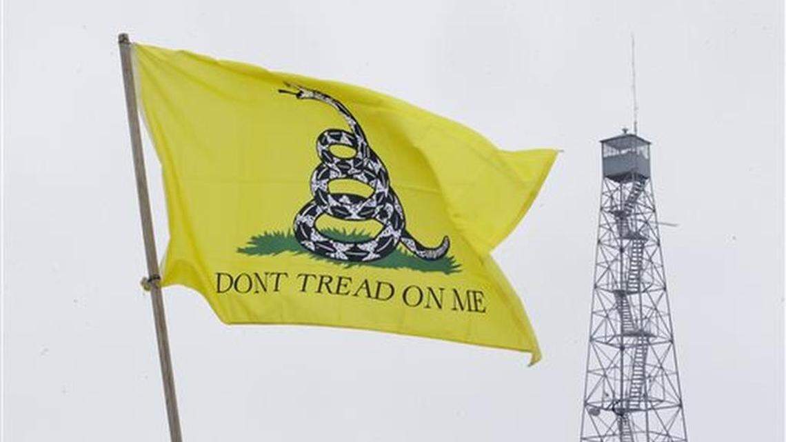 A Dont Tread On Me flag flies at the entrance of the Malheur National Wildlife Refuge Sunday, Jan. 10, 2016, near Burns, Ore. A small, armed group has been occupying the remote national wildlife refuge in Oregon for a week to protest federal land use policies.
