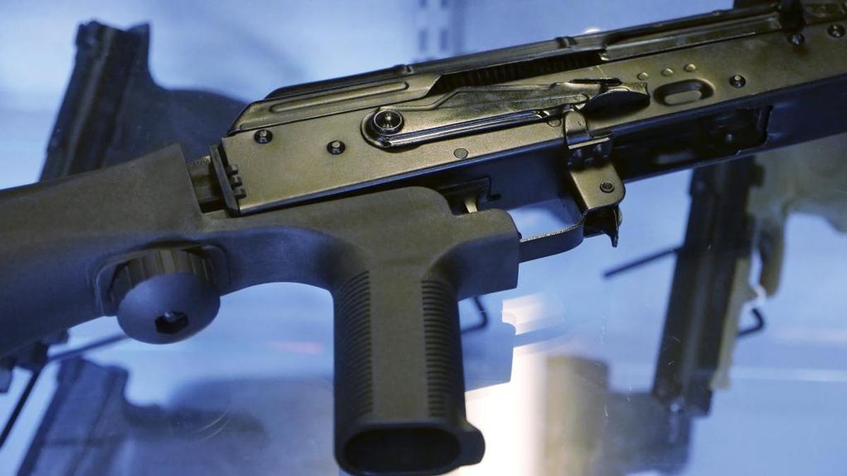A device called a “bump stock” is shown attached to a semi-automatic rifle at a gun store in Utah. Such a device, which allows a semi-automatic weapon to function as an automatic, was used by the gunman in the Las Vegas concert shooting Oct. 1.