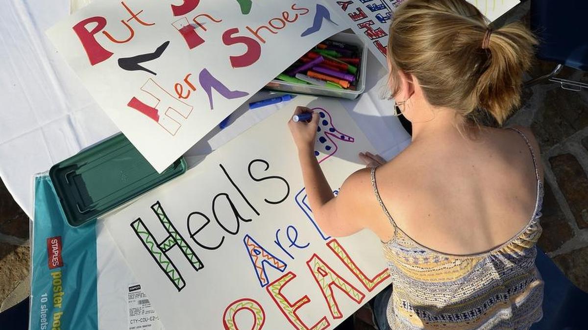 Posters are made for the Walk a Mile in Her Shoes march against sexual assault and gender violence in Kansas City in September.
