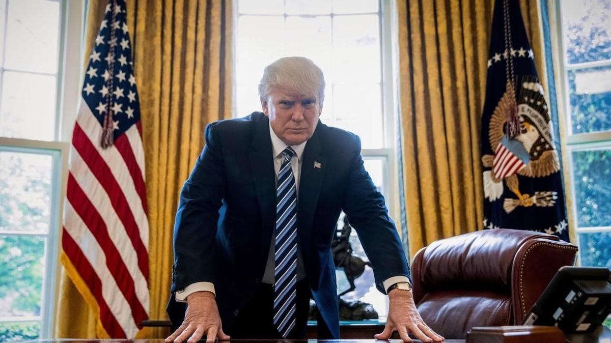 In this Friday, April 21, 2017, file photo, President Donald Trump poses for a portrait in the Oval Office in Washington. Trump will mark the end of his first 100 days in office with a flurry of executive orders as he looks to fulfill campaign promises and rack up victories ahead of that milestone. (AP)