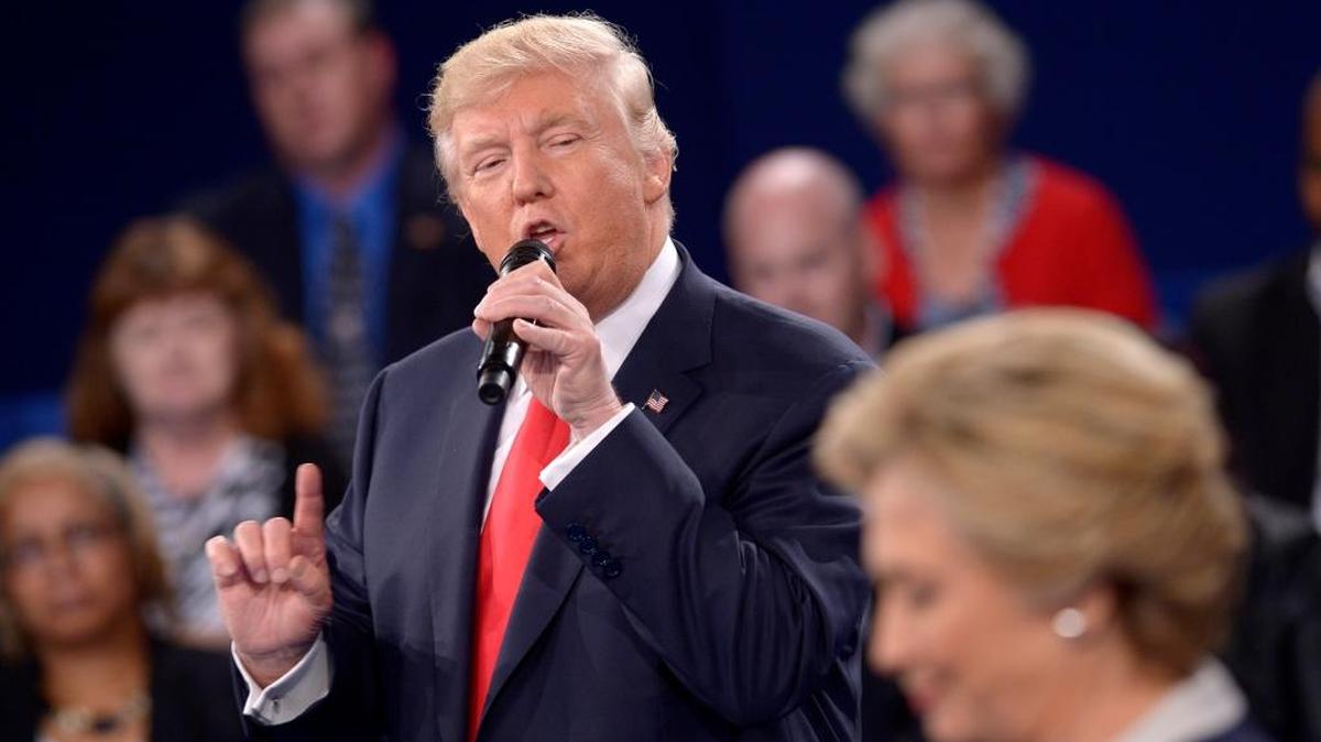 Republican presidential nominee Donald Trump speaks as Democratic presidential nominee Hillary Clinton listen during the second presidential debate at Washington University in St. Louis, Sunday, Oct. 9, 2016. (AP)