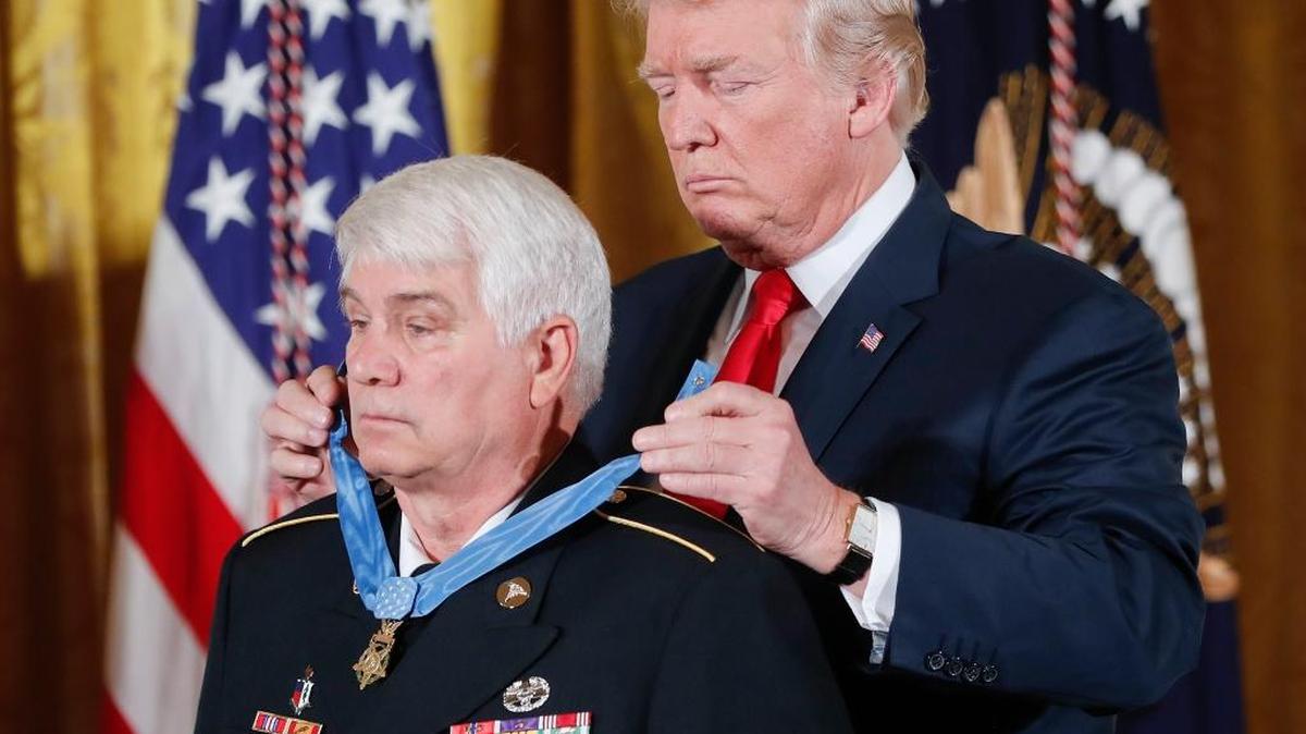 President Donald Trump bestows the Medal of Honor on retired Army medic James McCloughan during a White House ceremony Monday. McCloughan is credited with saving the lives of members of his platoon nearly 50 years ago in the Battle of Nui Yon Hill in Vietnam.