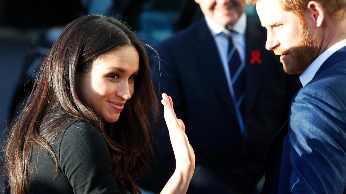 Britain's Prince Harry and his fiancee Meghan Markle leave the Nottingham Academy in Nottingham, England Friday.
