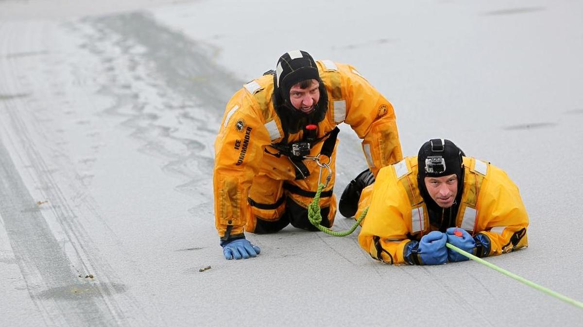 Brad Bolen, right, and Greg Briggs, members of the Boise Fire Department’s dive team, practiced ice rescues at ParkCenter pond earlier this month.