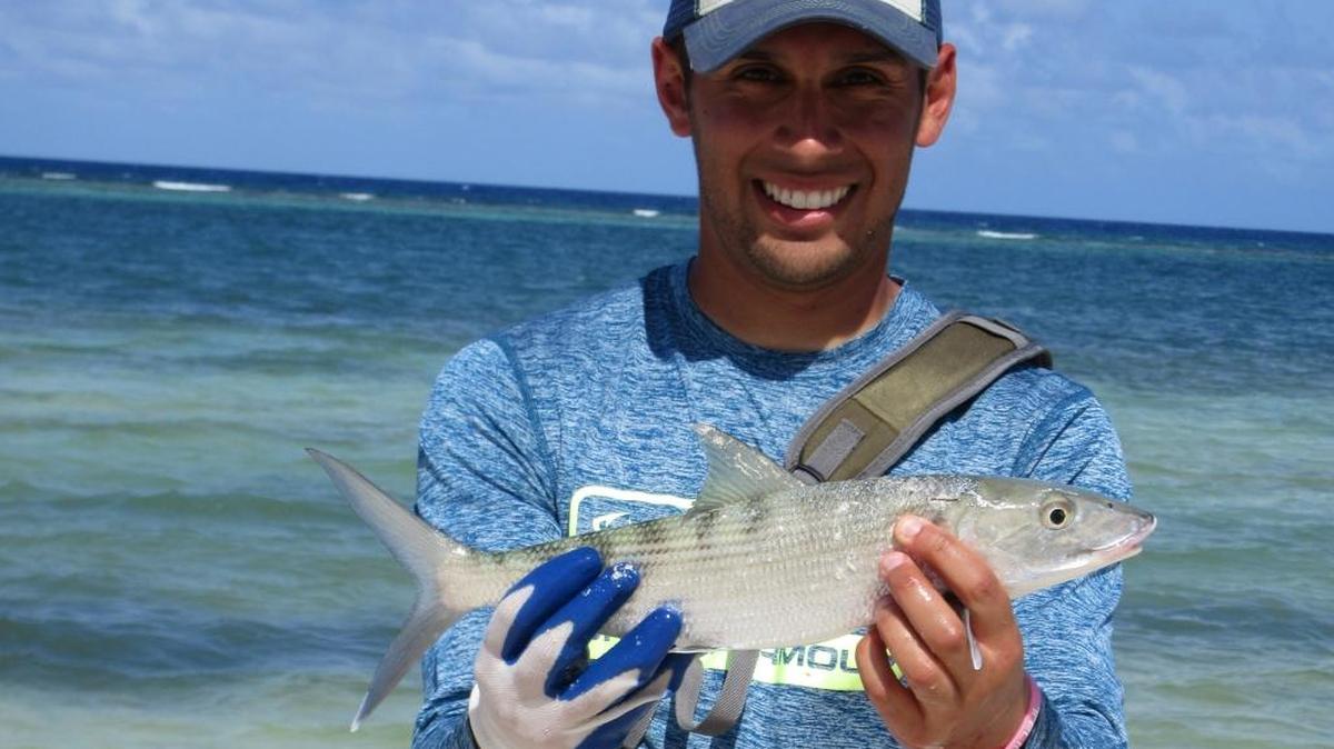 Fishing writer Jordan Rodriguez shows off the bonefish he caught in Belize.