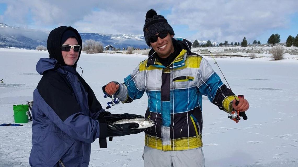 Local angler Justin Maxwell shows off the trout that almost got away with columnist Jordan Rodriguez’s favorite ice fishing rod at Lake Cascade.