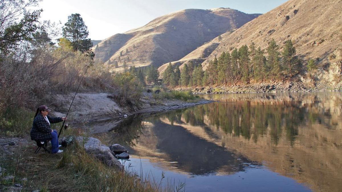 Julie Garcia of Grangeville fishes for steelhead from the bank of the Salmon River.