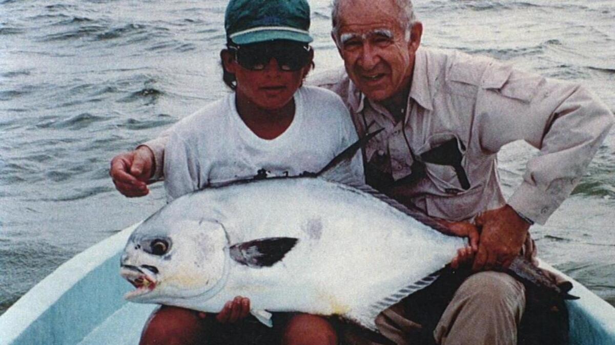 Famed Boise angler Winston Moore shows one of the 112 elusive saltwater permit he caught on a fly rod.