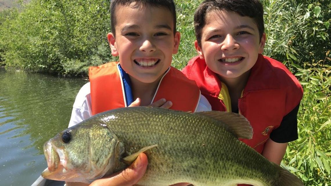 Catching a big fish always brings a smile to a young angler’s face — even if they need a little help holding it up for the picture.