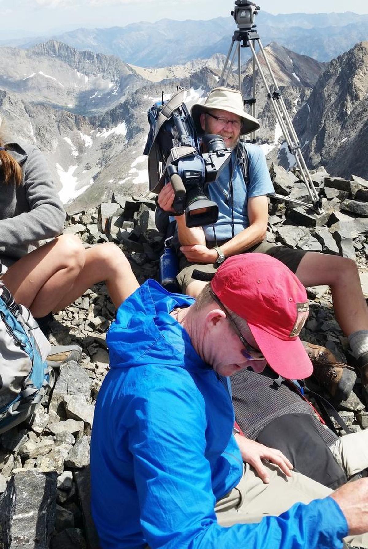 Even while resting at the summit of Old Hyndman Peak, videographer Jay Krajic has his camera on his shoulder.
