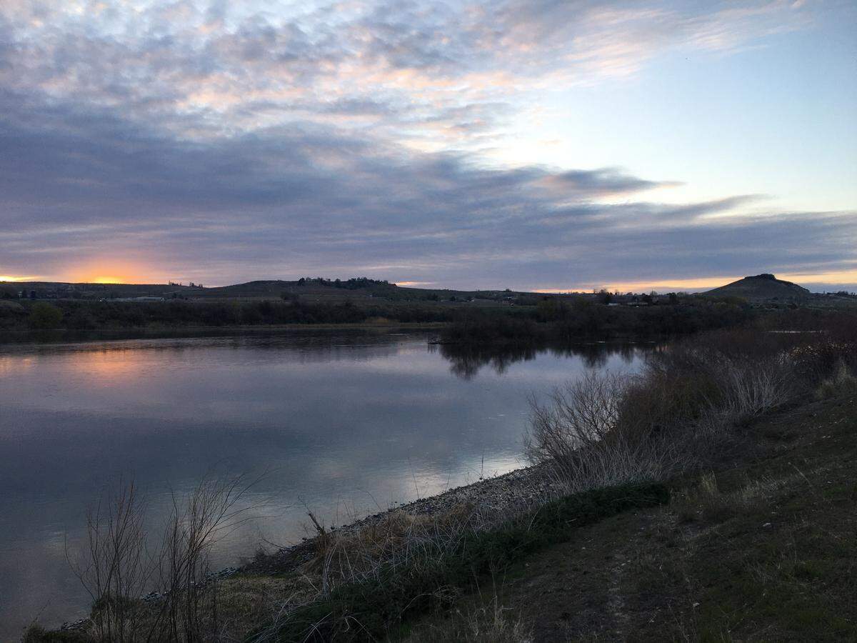 The sun rises over the Snake River in Marsing on April 15, our fifth morning on the river of a 206-mile journey on the entire length of the Snake River Water Trail. At the far right is Lizard Butte.