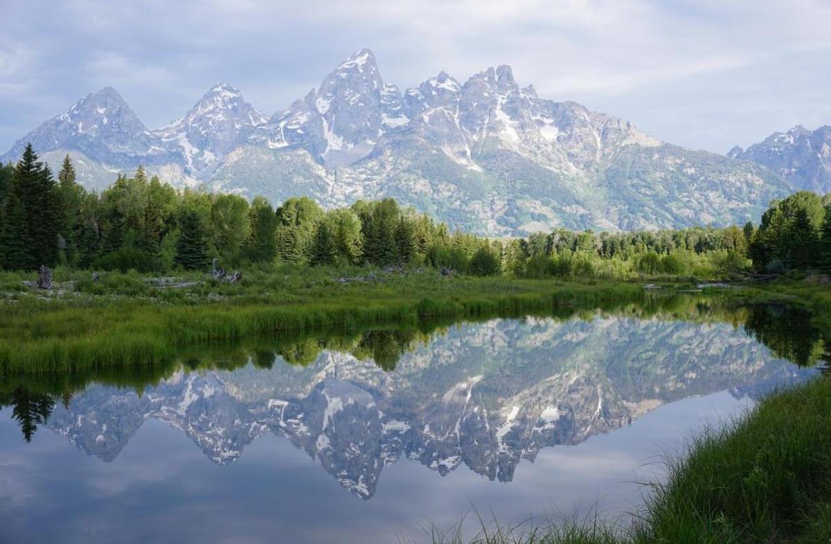 At Schwabacher’s Landing in Grand Teton National Park, the Snake River reflects the mountains in the morning light.