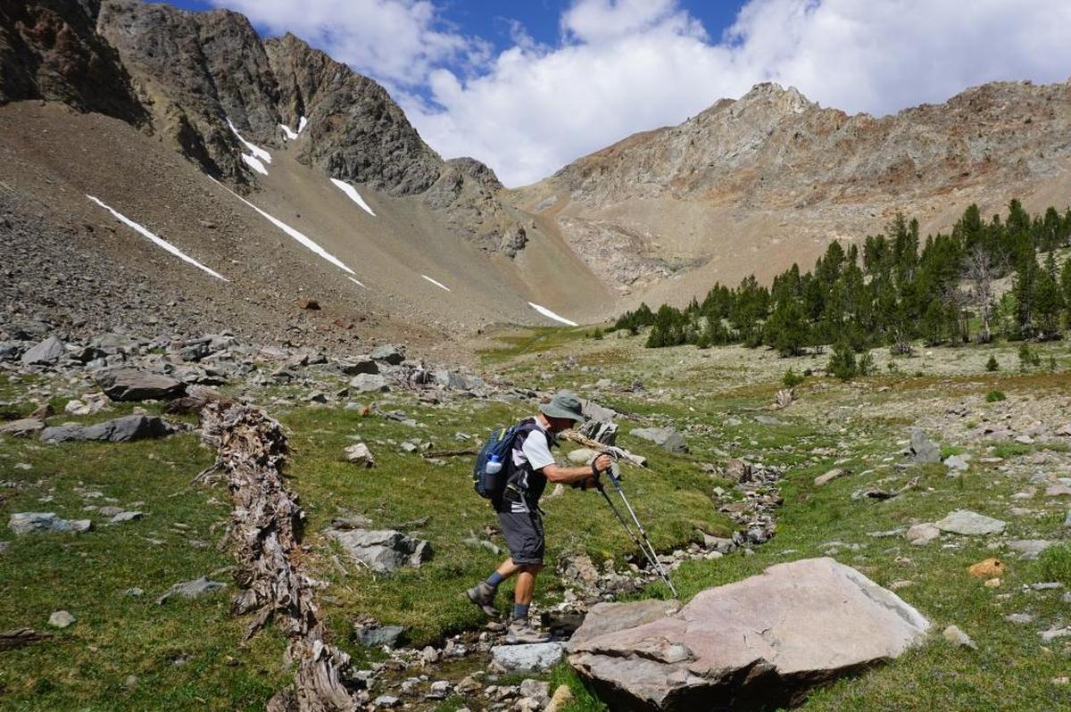 Rick Gerrard crosses a creek in the valley we explored on our third day in the Hemingway-Boulders Wilderness.