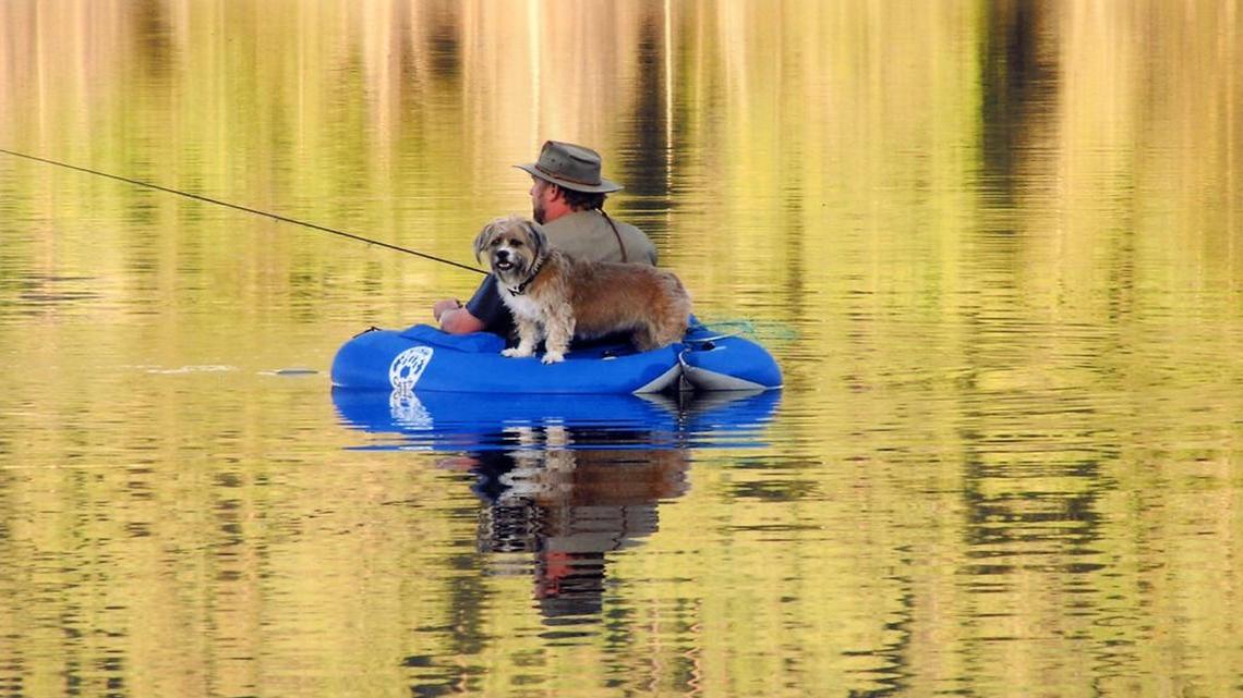 Mic Williams and dog Dayzee float at Horsethief Reservoir in 2004.