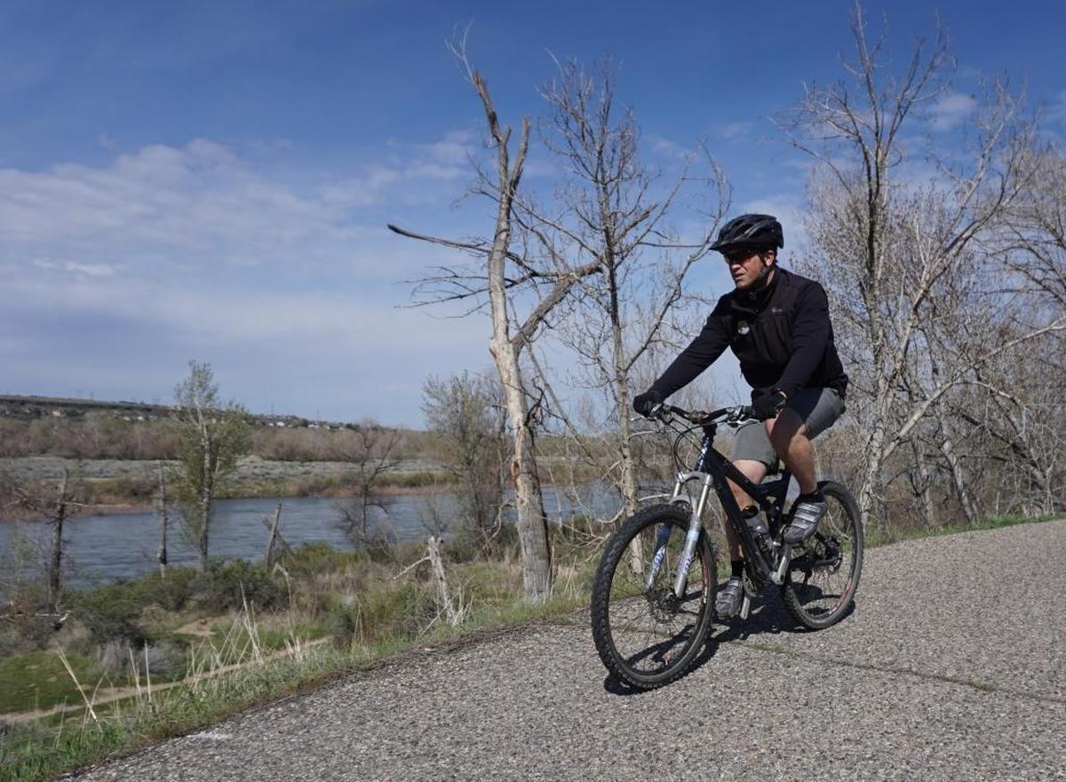 Scott Koberg, director of Ada County Parks & Waterways, rides the Greenbelt along Barber Pool in 2017. The path is narrow and lacks a dividing line in that section, which makes it unsuitable for young children, he said.
