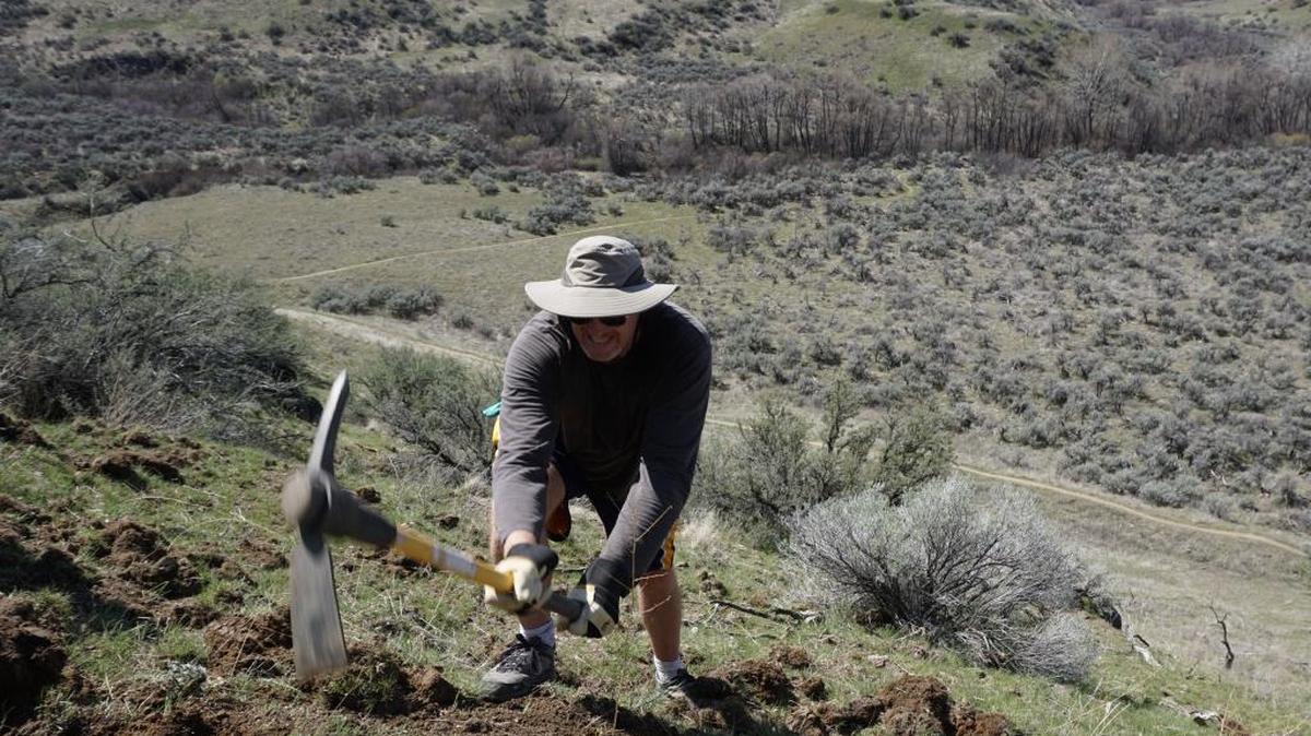 Luke ten Doeschate helps build a new mountain bike trail in the Avimor community. The trail system is open to the public.