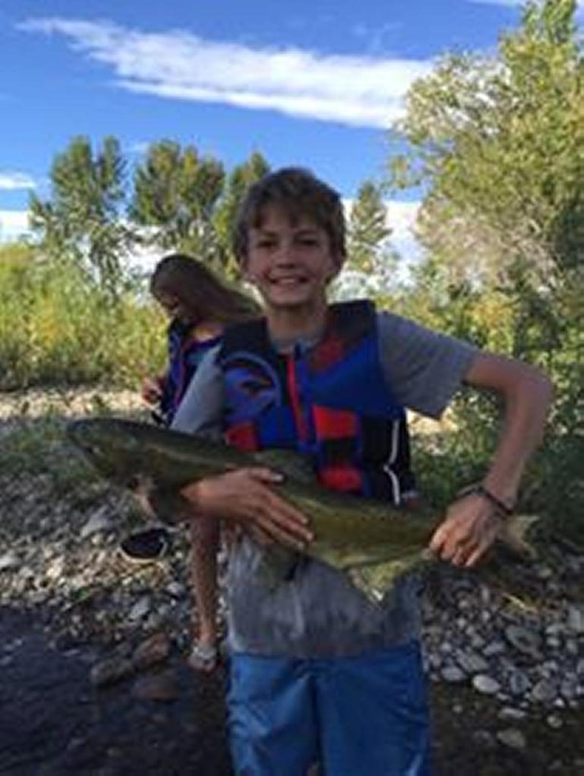 A young boy caught a 35-inch brown trout in the Boise River.
