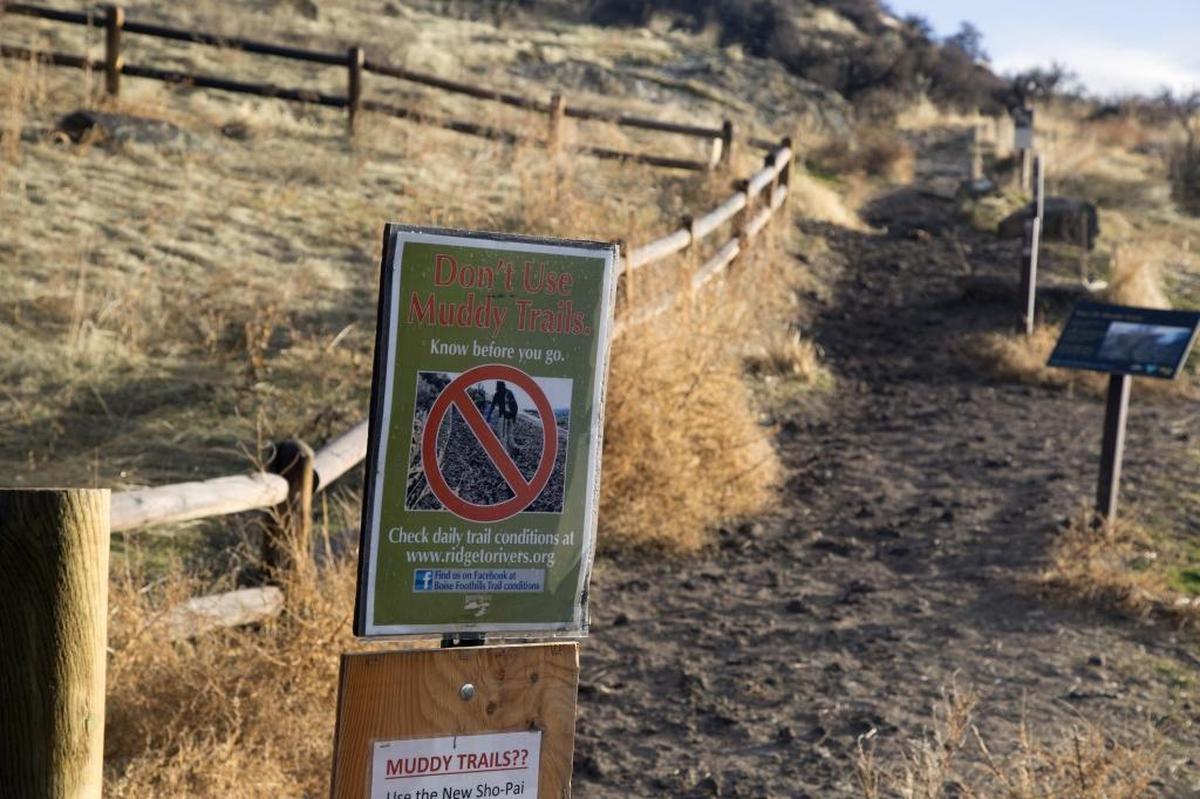 Signs at some trailheads remind hikers, bikers and runners to stay off muddy trails.