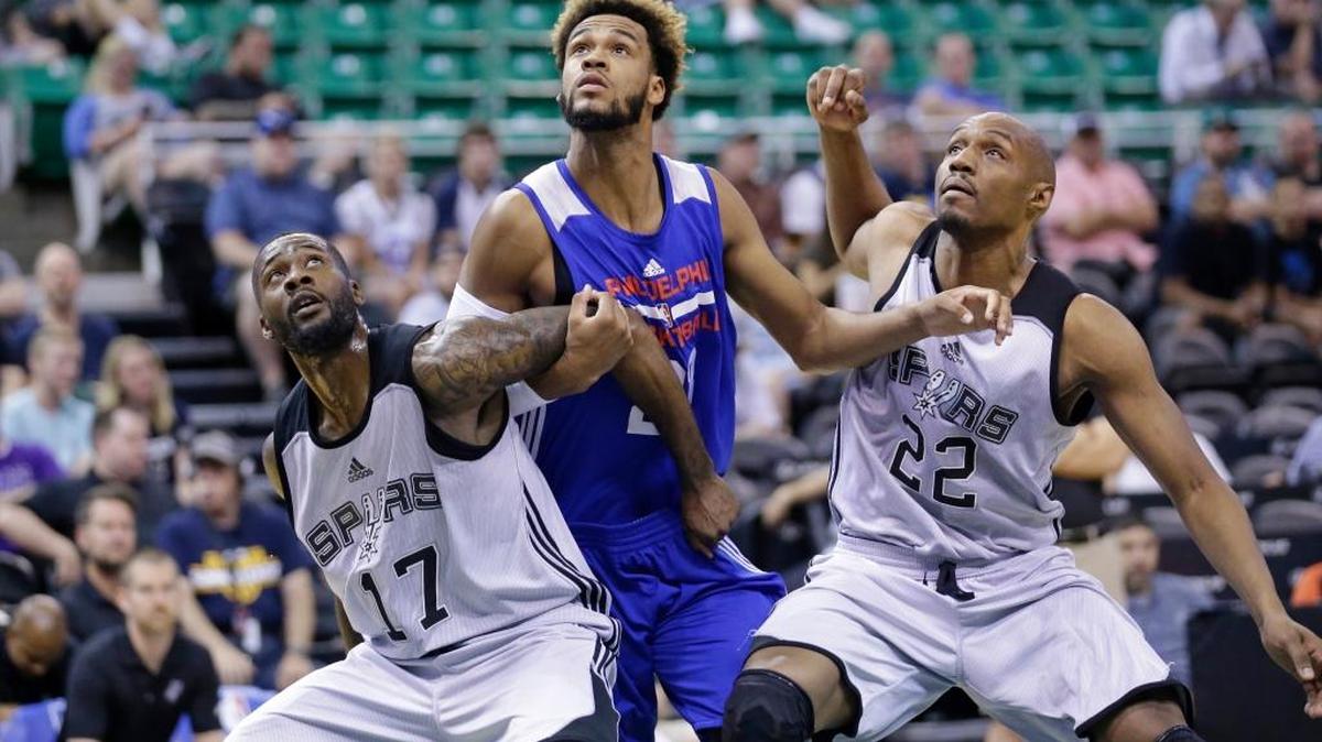 Philadelphia 76ers forward James Webb III, center, works under the basket between San Antonio Spurs’ Jonathon Simmons (17) and CJ Williams (22) during the first half of an NBA summer league basketball game Tuesday, July 5, 2016, in Salt Lake City.
