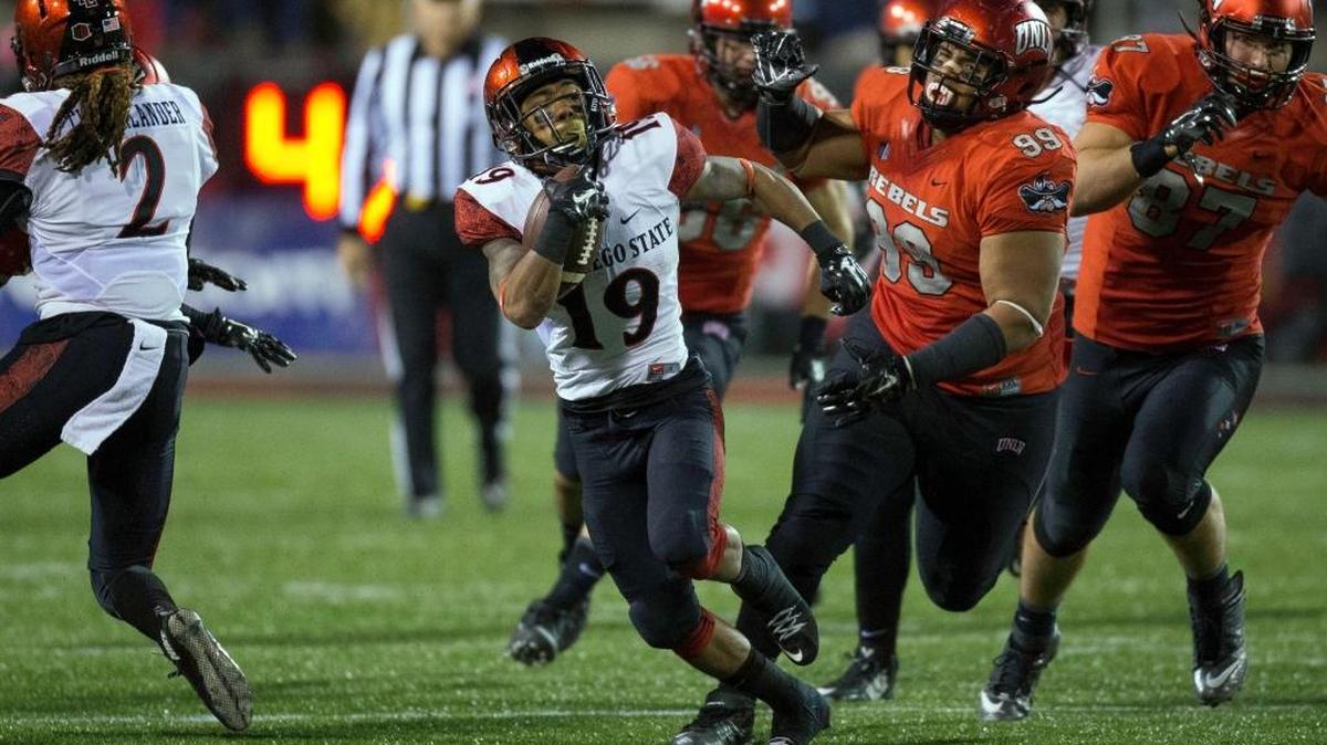 San Diego State running back Donnel Pumphrey (19) breaks past UNLV defensive lineman Mike Hughes Jr. (99) during the first half of an NCAA college football game Saturday, Nov. 21, 2015, at Sam Boyd Stadium in Las Vegas. The Aztecs clinched the West Division before kickoff with Nevada’s 31-27 loss to Utah State.