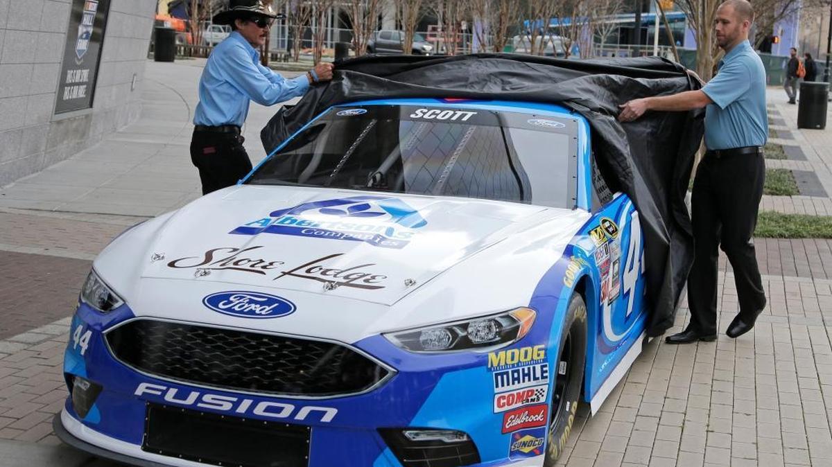 Team owner Richard Petty, left, and driver Brian Scott, right, unveil the No. 44 car Scott will drive this season during the Charlotte Motor Speedway NASCAR Media Tour on Wednesday in Charlotte, N.C.
