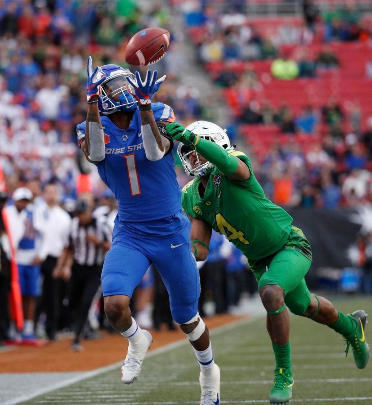 Former Boise State wide receiver Cedrick Wilson catches a pass over Oregon cornerback Thomas Graham Jr. during the second half of the Las Vegas Bowl in 2017.