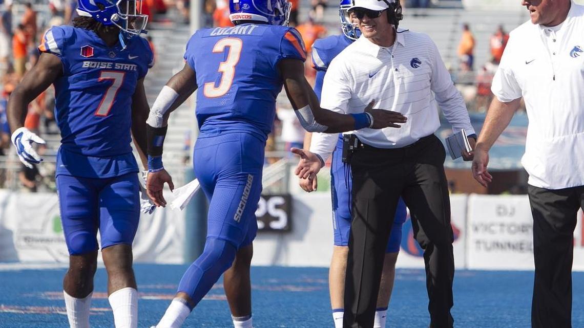 Boise State quarterback Montell Cozart (3) is congratulated by head coach Bryan Harsin after Cozart’s touchdown pass in the fourth quarter of the home opener against Troy on Saturday at Albertsons Stadium.