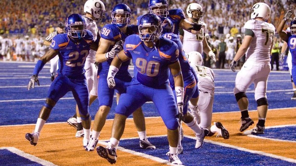 Boise State’s defense, led by Billy Winn, celebrates during the 2009 game against Oregon. The Broncos won 19-8 in front of 34,127 fans — a school record at the time.