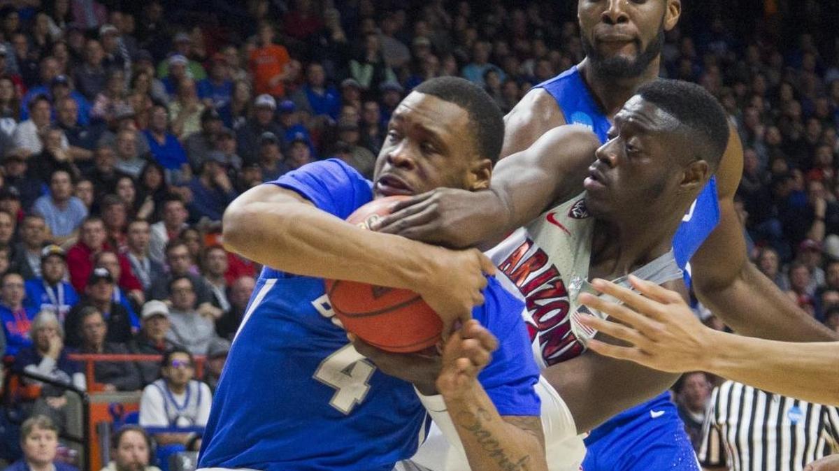 Buffalo guard Davonta Jordan wrestles with Arizona’s Rawle Alkins in the first round of the NCAA men’s basketball tournament Thursday in Boise.