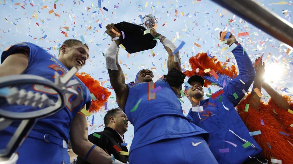 From left, Boise State linebacker Leighton Vander Esch, wide receiver Cedrick Wilson, and head coach Bryan Harsin celebrate after beating Oregon in the 2017 Las Vegas Bowl.