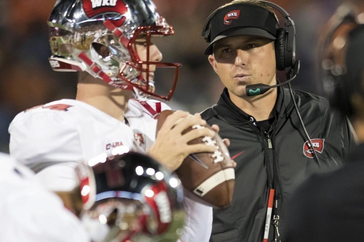 Western Kentucky coach Mike Sanford talks to quarterback Mike White during a game in 2018. Sanford was fired after that season and was hired as Utah State’s offensive coordinator less than a month later. 