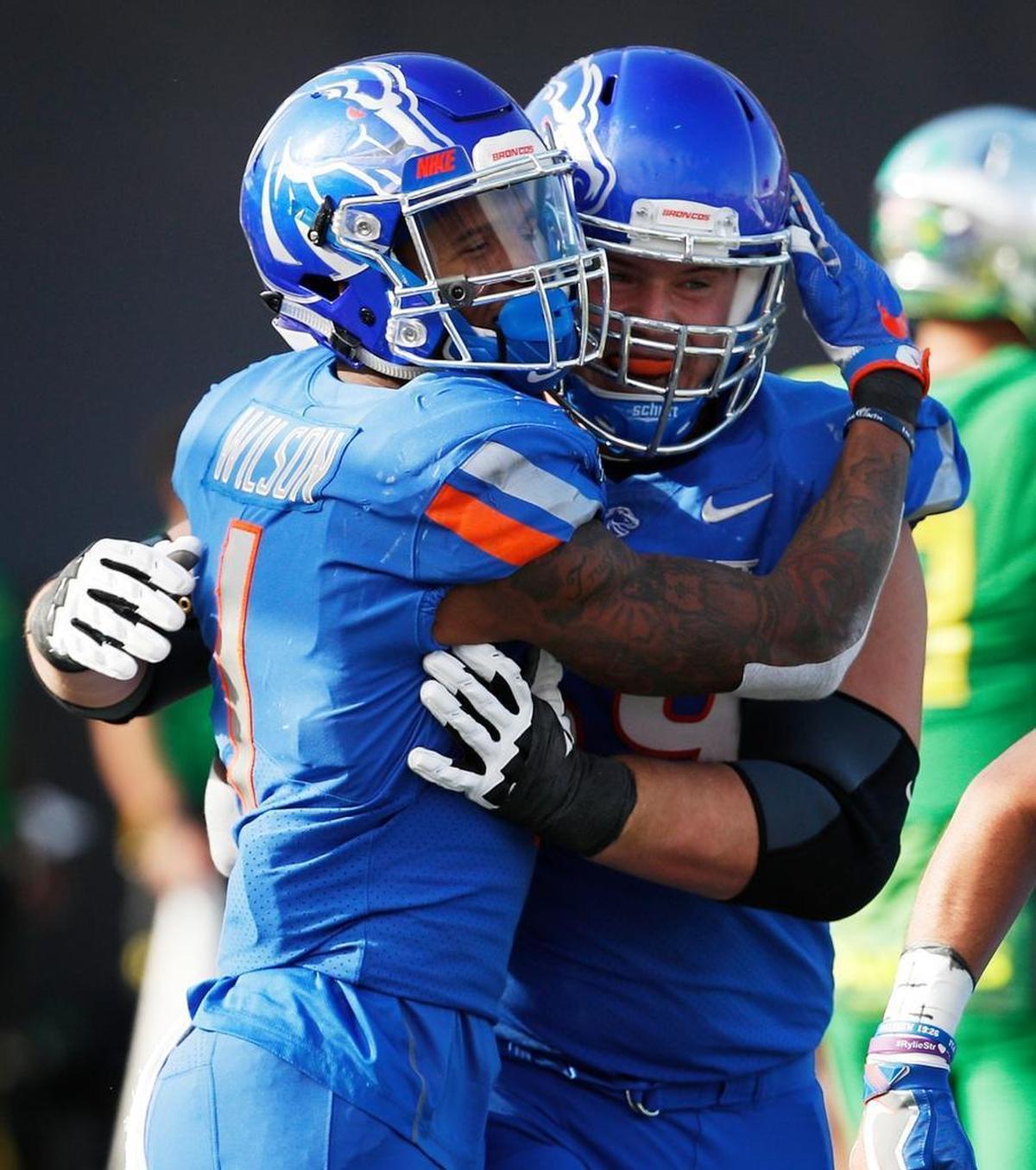 Boise State wide receiver Cedrick Wilson celebrates with offensive lineman Mason Hampton, right, after scoring a touchdown against Oregon in the Las Vegas Bowl.