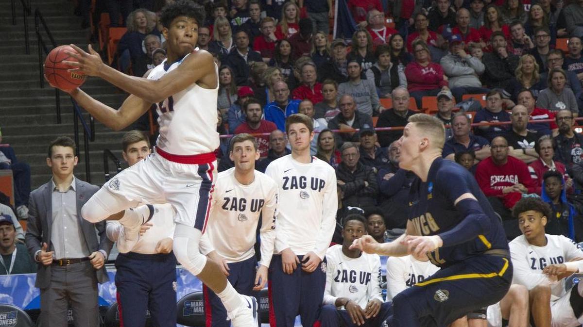 Gonzaga forward Rui Hachimura saves the ball from going out of bounds with a deflection off UNC Greensboro’s Jordy Kuiper in the first round of the NCAA men’s basketball tournament West Regional on Thursday at Taco Bell Arena in Boise.
