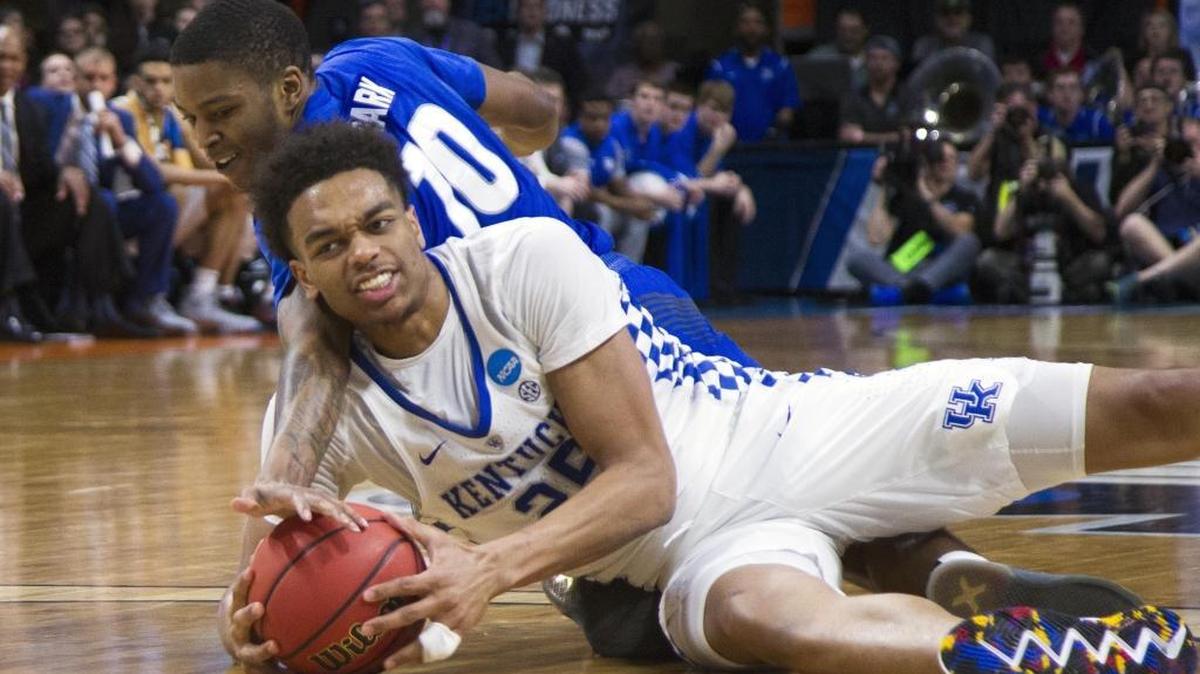 Kentucky forward PJ Washington, front, and Buffalo’s Wes Clark scramble for a loose ball Saturday in the second round of the NCAA men’s basketball tournament at Taco Bell Arena in Boise.