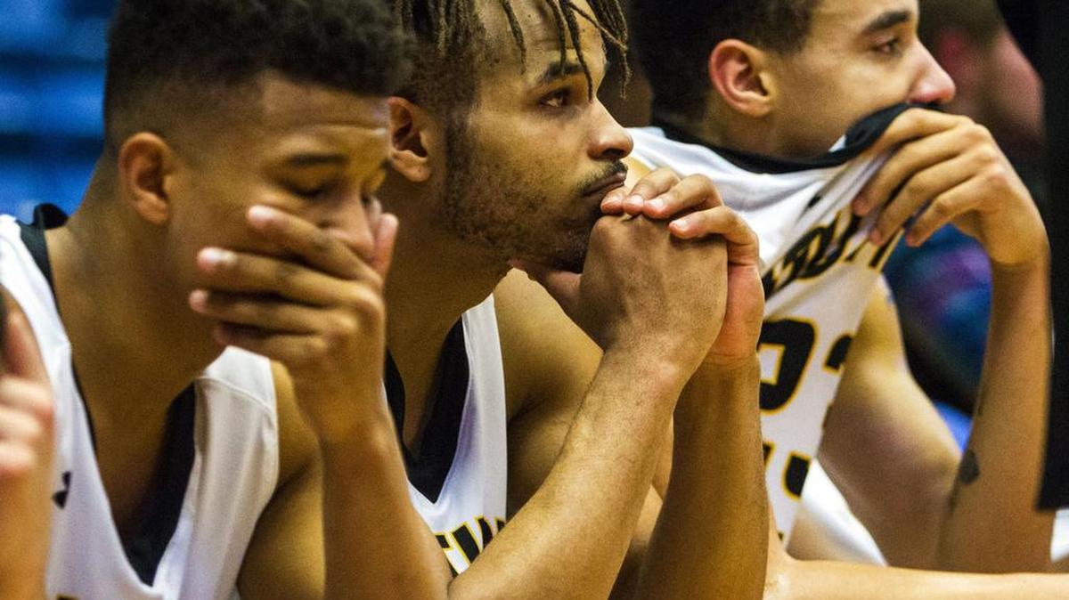 From left, Southern Idaho’s Keion Peterson, Charles Jones Jr. and Khalid Thomas can only watch as South Plains celebrates its NJCAA national title.