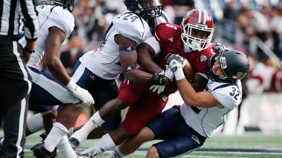 Akron defensive back Jordan George, left, and safety Zach Guiser are part of a Zips defense that allowed 100 or fewer rushing yards in seven games this season, including 100 in the season opener against Oklahoma.