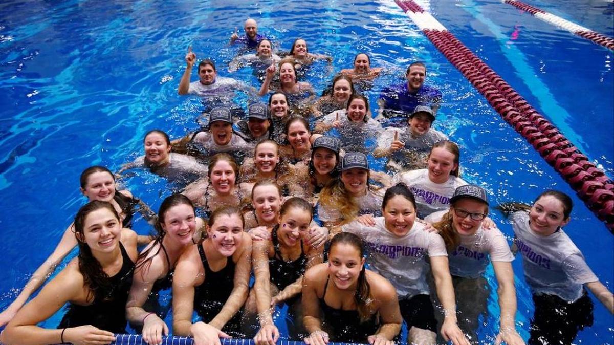 The Broncos swimming and diving team celebrates its conference title.