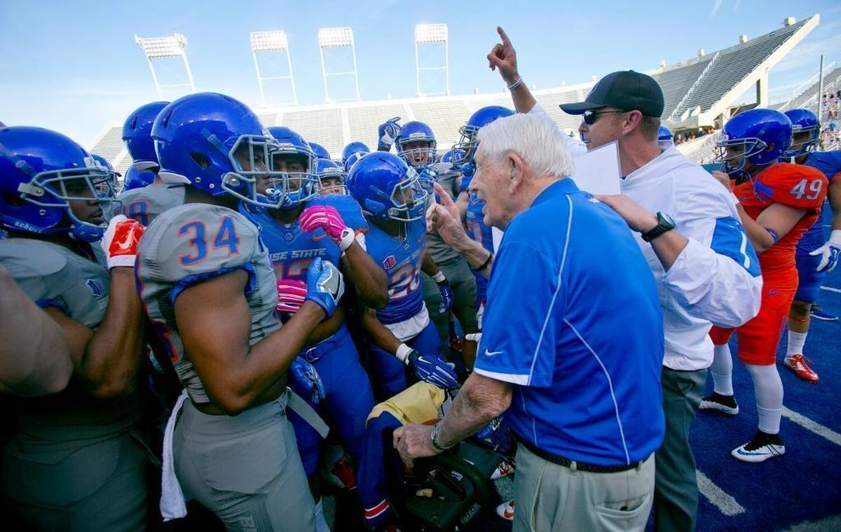 Boise State head football coach Bryan Harsin, right, and the Broncos cheer legendary coach Lyle Smith before the spring game at Albertsons Stadium in April 2016.