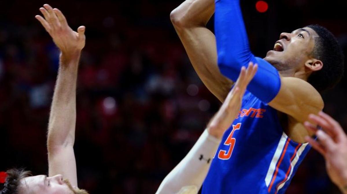 Boise State junior Chandler Hutchison goes up for a shot over Utah forward David Collette during their first-round NIT game in Salt Lake City on Tuesday, March 14, 2017.
