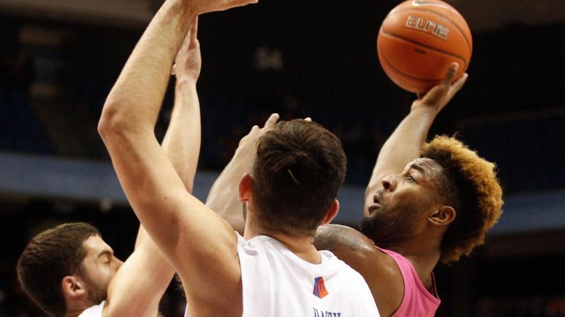 Nevada’s Jordan Caroline shoots over Boise State defenders David Wacker, left, and Zach Haney in the second half of their game at Taco Bell Arena on Wednesday night.