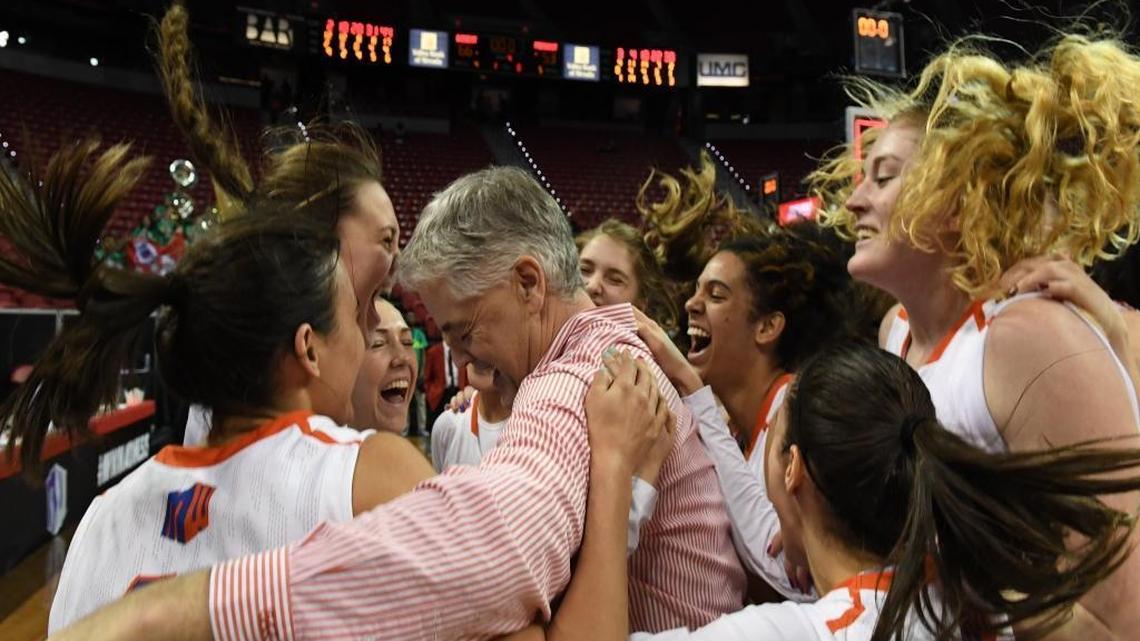 Boise State women’s basketball coach Gordy Presnell and his players celebrate after beating Fresno State in the Mountain West Tournament championship game and clinching a berth in the NCAA Tournament.