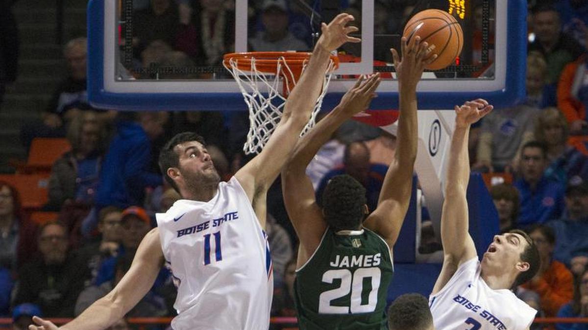 Boise State forward Zach Haney blocks a shot by Colorado State forward Deion James, also defended by BSU guard Justinian Jessup, on Dec. 27, 2017, at Taco Bell Arena in Boise.