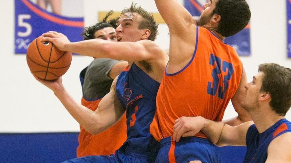 Boise State basketball player Anthony Drmic (3, middle) drives and scores on David Wacker (33) and Zach Haney (back, 11) during a scrimmage last month in Bronco Gym.
