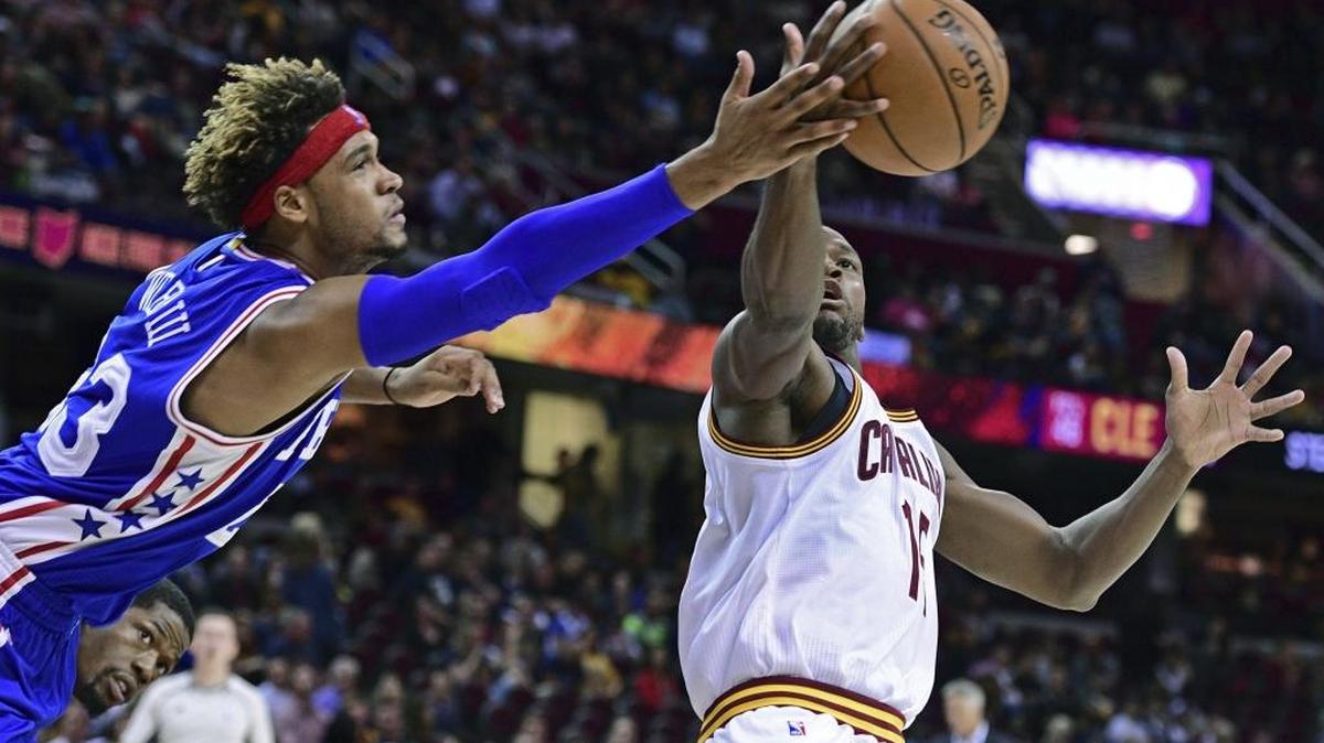 Cleveland’s Toney Douglas, right, grabs a rebound against Philadelphia’s James Webb III during the second half of their preseason game Oct. 8 in Cleveland.